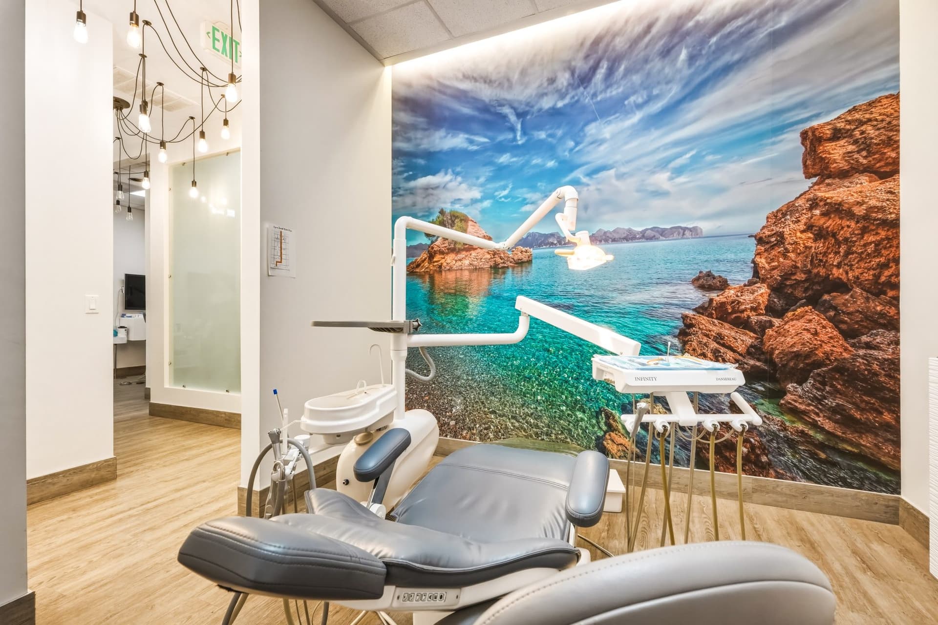 Treatment room with a coastal mural at Agoura Dental Group